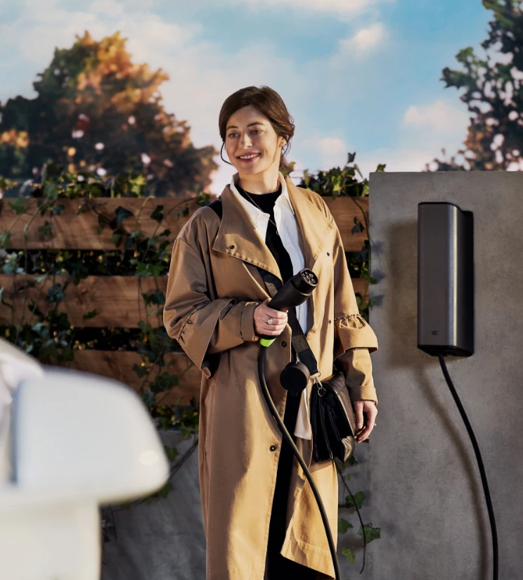 A woman next to a wall charger